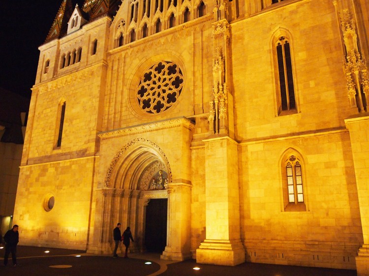 Two passersby show the massive size of the church. 